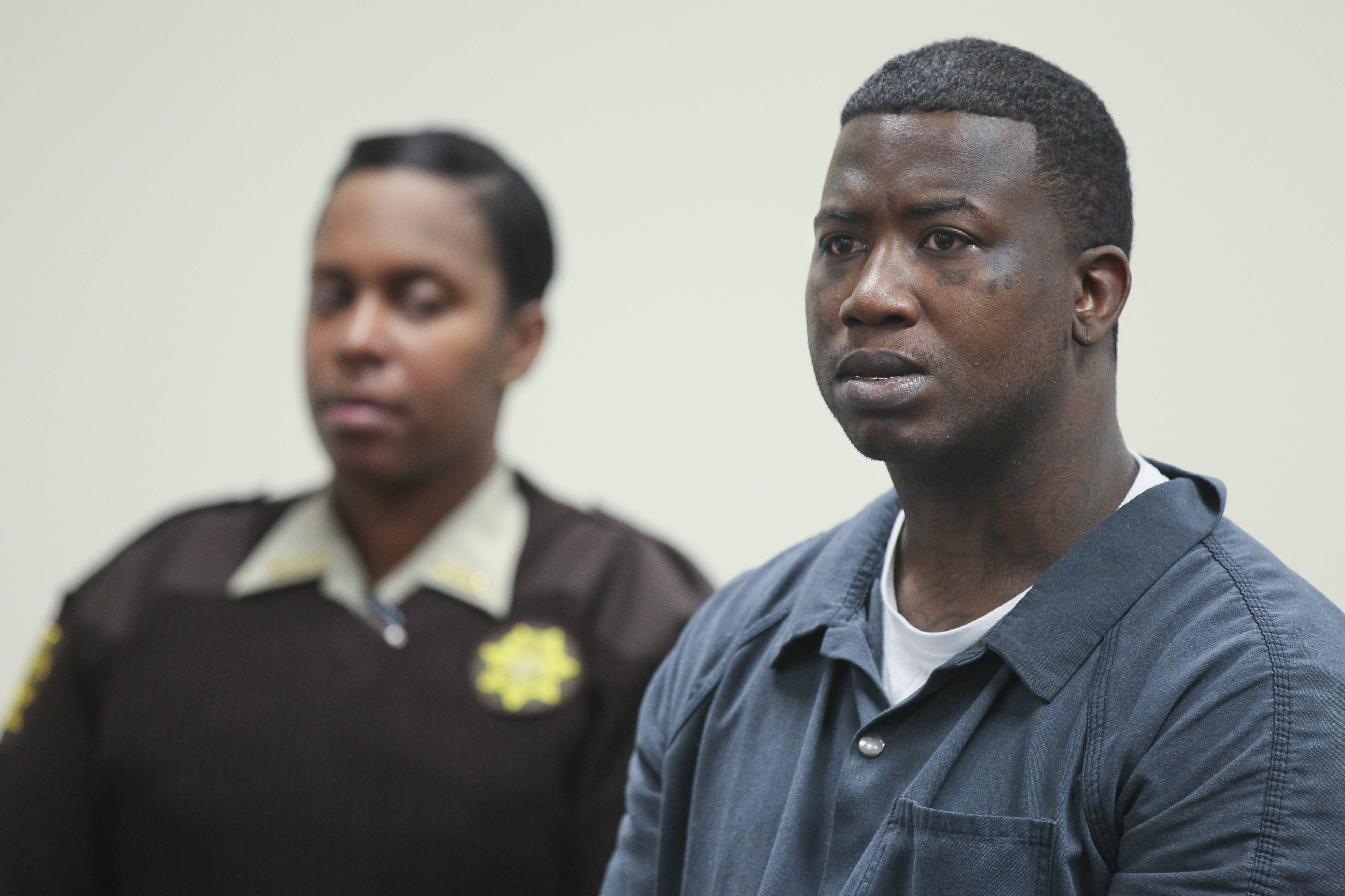 Mar. 27, 2013 Atlanta: Fulton County Sheriff deputy T. Reynolds (left) looks on as defendant Radric Davis (right) listens. Rapper Gucci Mane was denied bond Wednesday at his first court appearance after his arrest for allegedly assaulting a soldier earlier this month at an Atlanta nightclub. His next court date is April 10. The musician, whose real name is Radric Davis, was booked into the Fulton County Jail Tuesday, charged with aggravated assault with a weapon, according to online jail records. Fulton County sheriff’s spokeswoman Tracy Flanagan said Davis turned himself in at the jail about 11:30 p.m. Tuesday, and will face a magistrate for a first appearance at 11 a.m. Wednesday. Channel 2 Action News reported last week that Atlanta police had issued a warrant for the rapper following the March 16 incident at the Harlem Nights club on Courtland Street. The alleged victim told Channel 2 that Davis hit him in the head with a champagne bottle after he asked to take a photo with the rapper. “I’m in the military. I wanted to get a picture with Gucci Mane, is it okay?” the soldier said he asked a security guard. “I was speaking to the security guard, and Gucci Mane hit me in the head with a bottle,” the solder told Channel 2. The soldier told the station that he went to Grady Memorial Hospital by ambulance, and his injury required 10 stitches. JOHN SPINK / JSPINK@AJC.COM